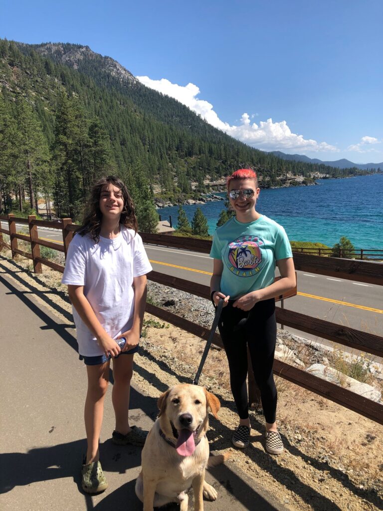 Lake Tahoe 2 girls and yellow lab on path by lake